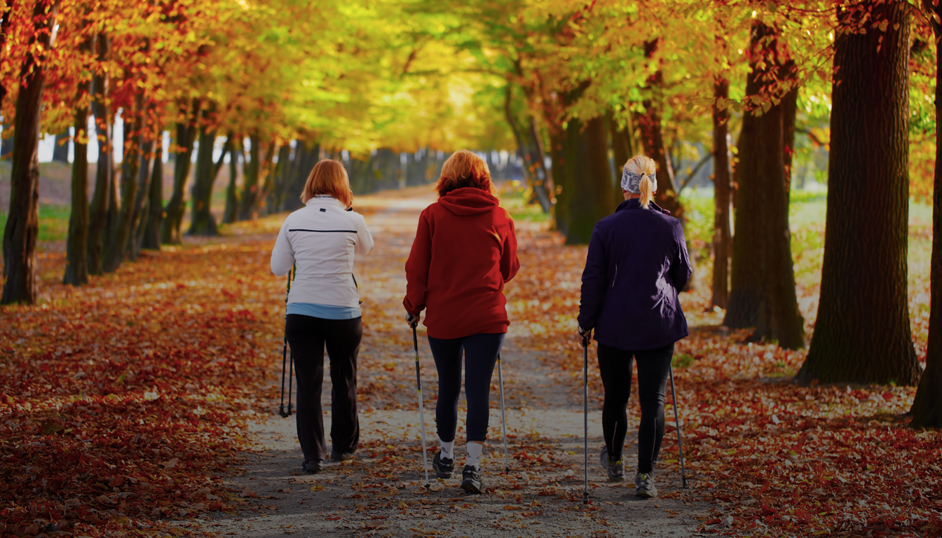 Three women Nordic walking on outdoor forest trail