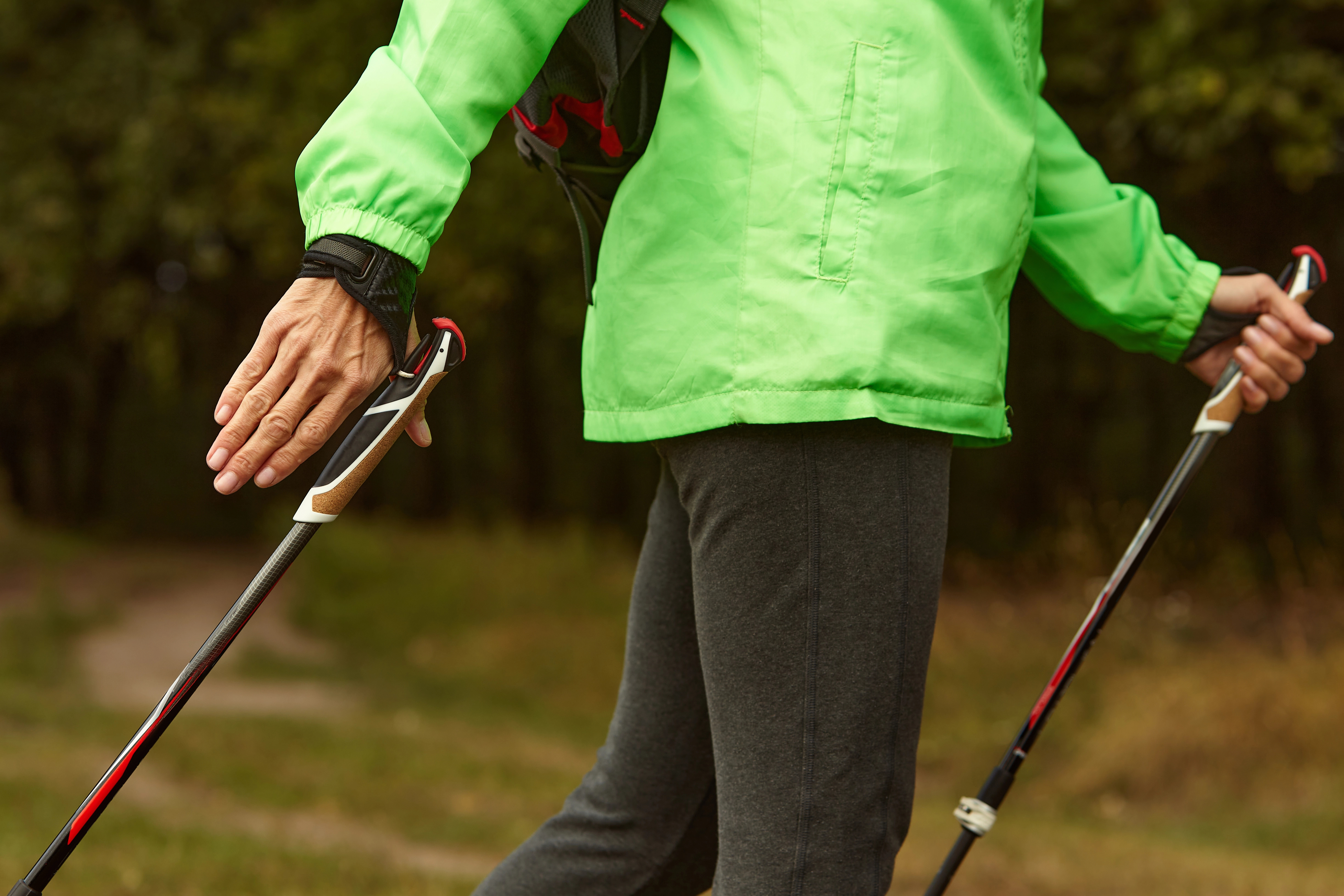 Nordic walking poles held in hands with gloves