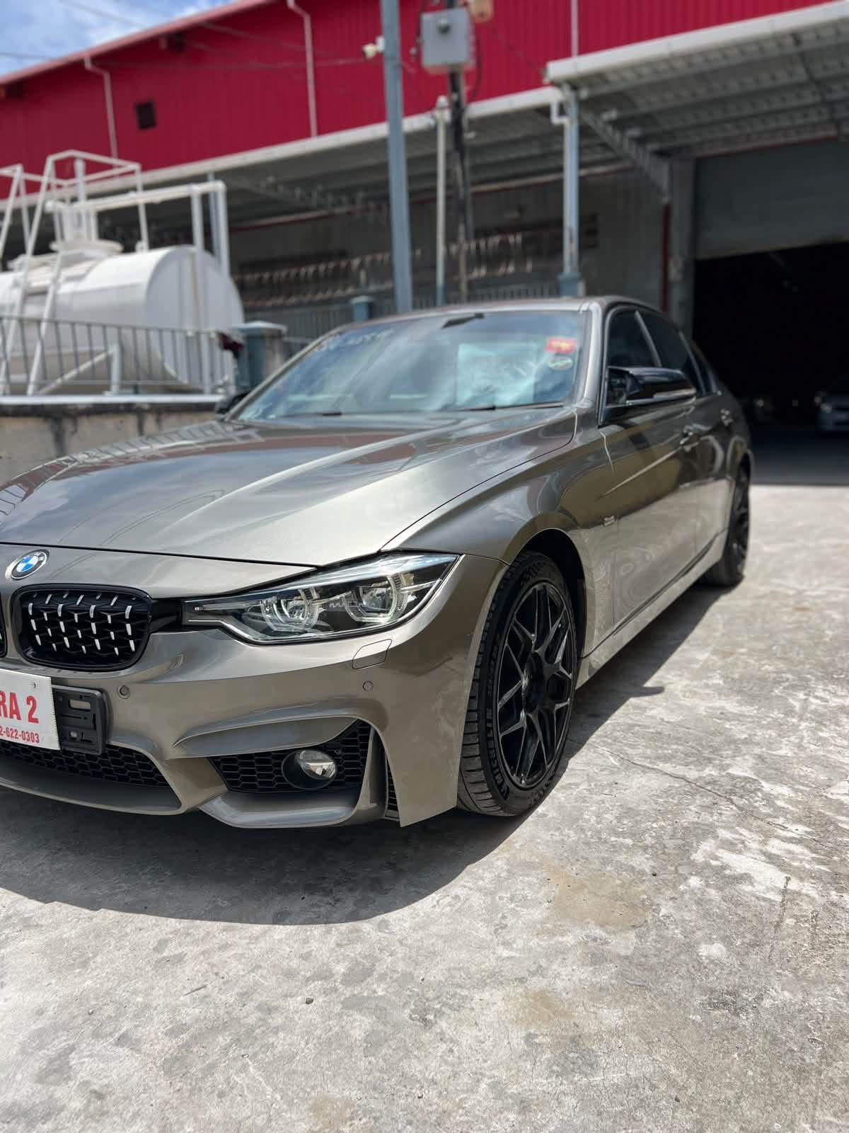 2016 BMW 318 bronze — side angle view showing sleek roofline and black alloy wheels