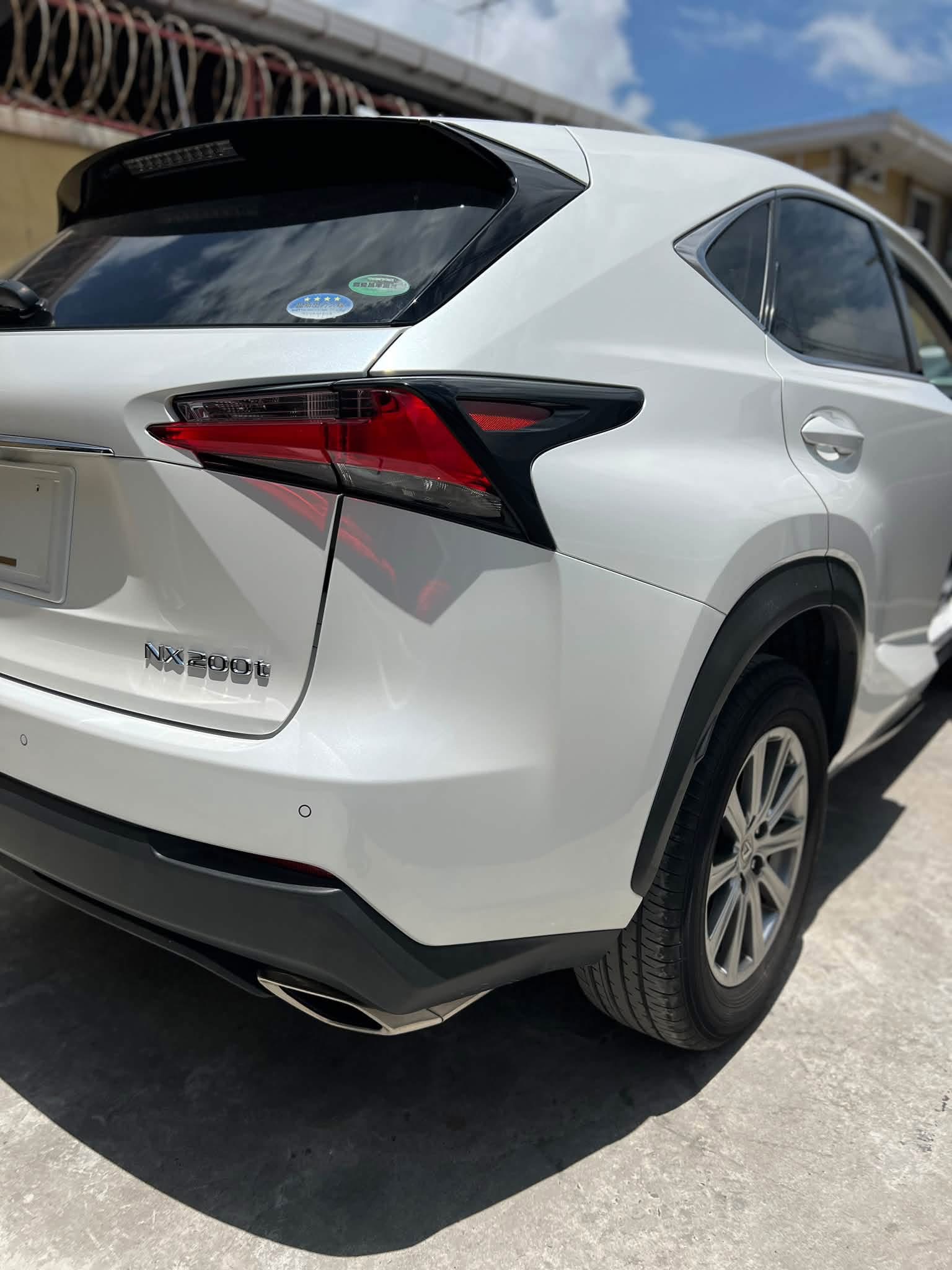 2015 Lexus NX200T Pearl White — rear three-quarter view showing NX200t badge and LED tail lights
