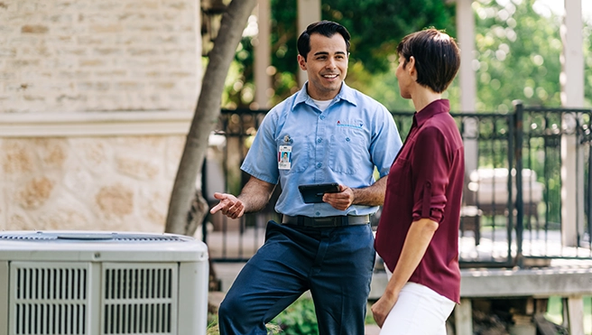 Aire Serv technician consulting on AC system
