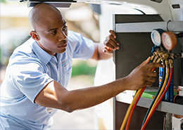 Aire Serv technician explaining HVAC system to female customer