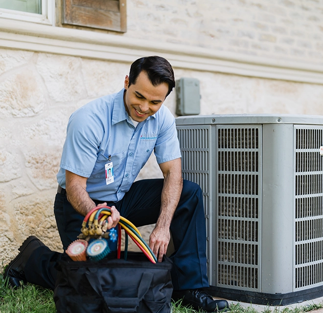 Aire Serv technician explaining HVAC system to female customer