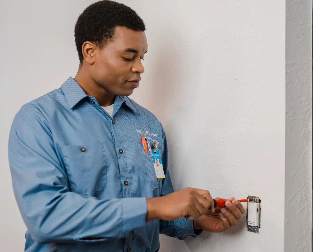 Professional electrician installing an outlet