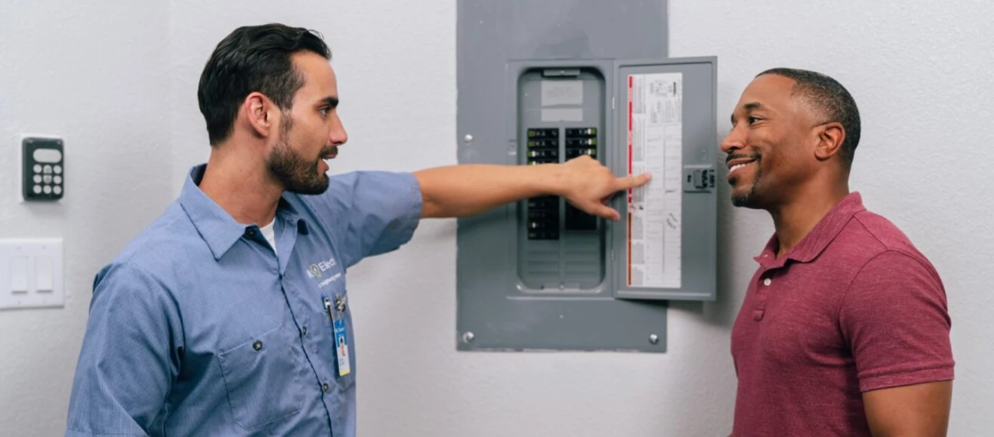 Electrician explaining panel to customer