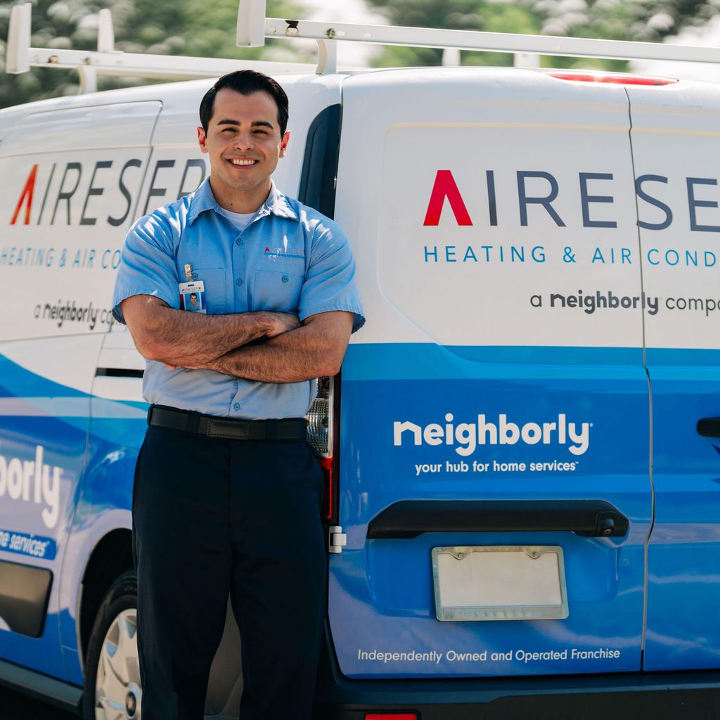 Aire Serv technician standing in front of service van