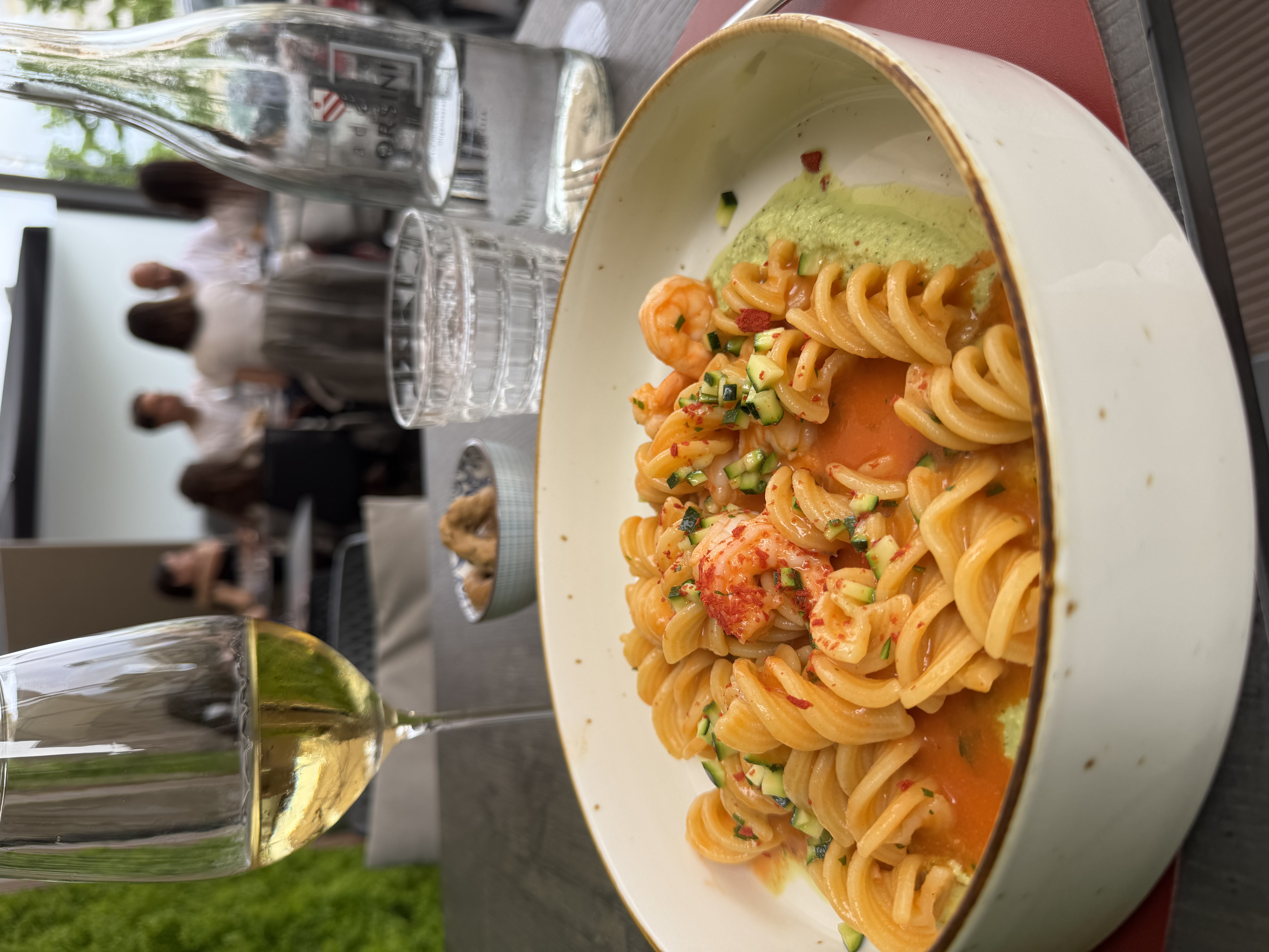 Elegantly plated pasta with shrimp paired with white wine