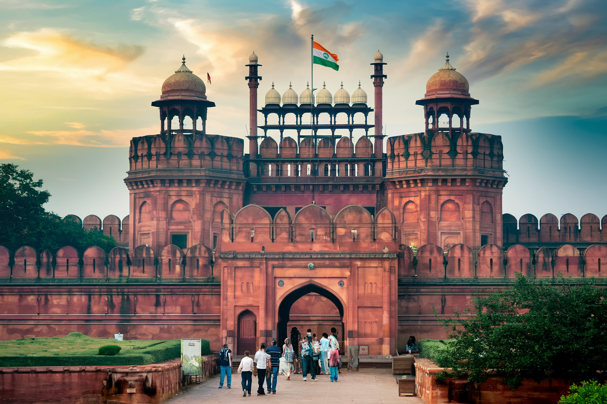 The majestic Red Fort in Delhi with its iconic red sandstone walls and the Indian flag flying above the Lahori Gate