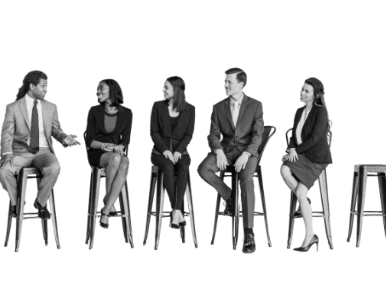 Five diverse business professionals seated on stools in conversation